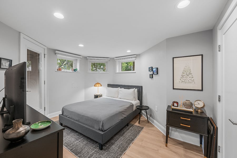 Queen bedroom with dedicated workspace (not shown) and direct exterior entrance.