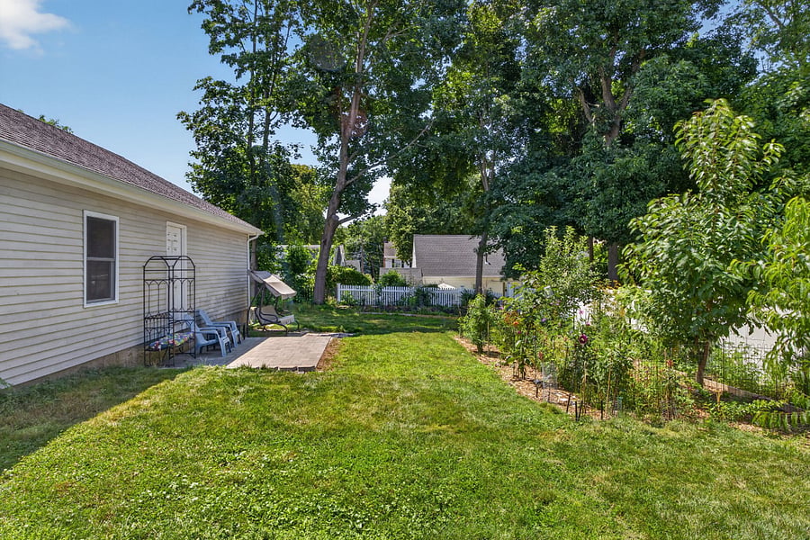 deep backyard with fruit trees and vegetables in the summer
