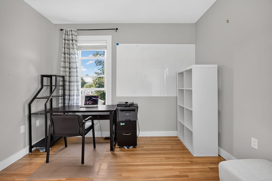 Office space with bookshelf and white board