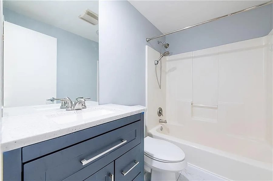 Private full bathroom with updated vanity, tub-and-shower combination, and modern finishes