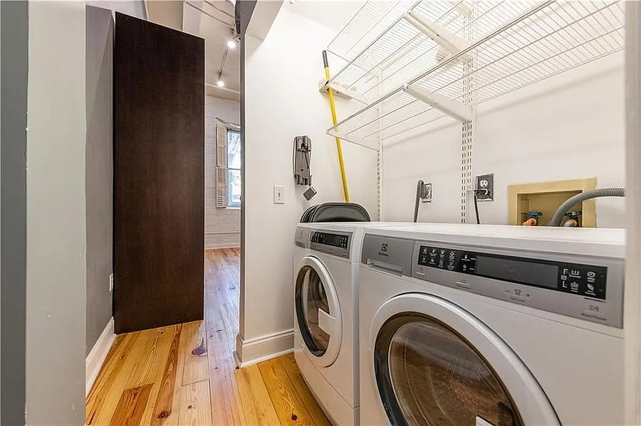 Full-size in-unit washer and dryer with additional shelving and utility storage