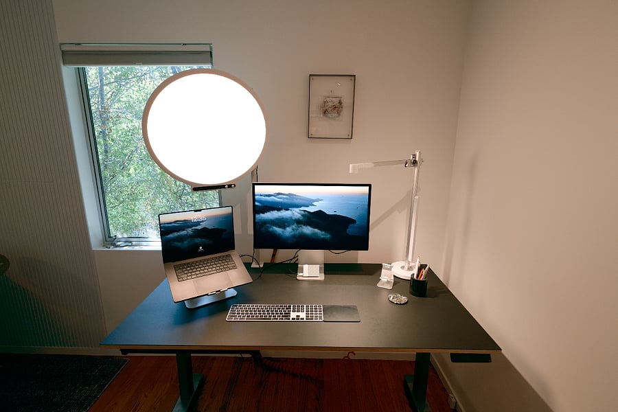 Standing desk, Apple Studio Display, studio lighting and microphone