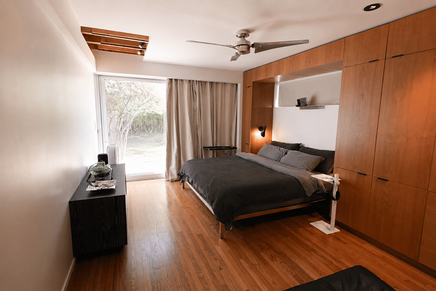 Master bedroom with king bed, wall projector, Apple TV, and sound system