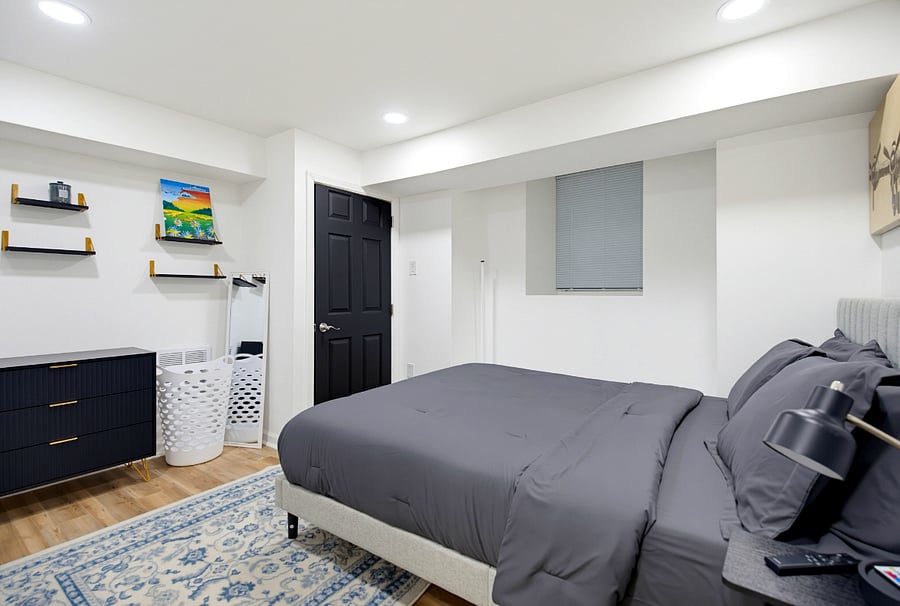 Comfortable queen-size bed with convenient bedroom storage shelving.