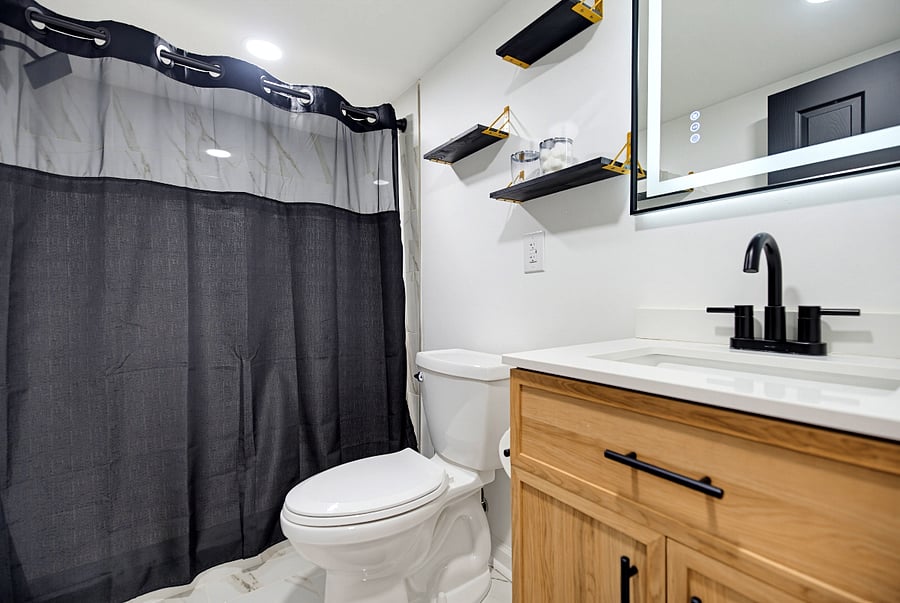 Private bathroom with a closed shower curtain.