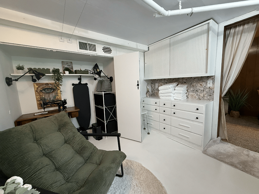 Shared laundry room with full-size washer and dryer, used by both the tenant and homeowners.