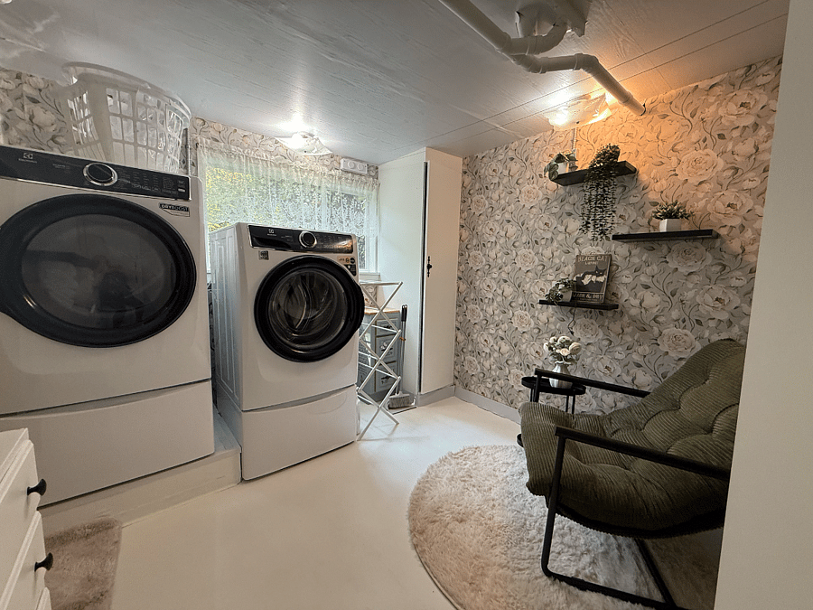 Shared laundry room with full-size washer and dryer, used by both the tenant and homeowners.