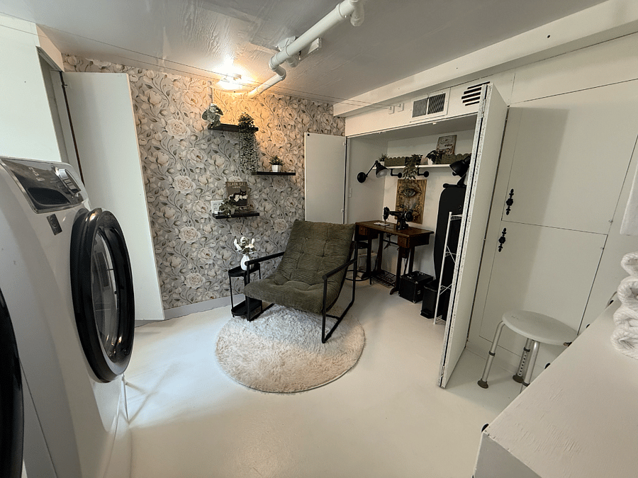 Shared laundry room with full-size washer and dryer, used by both the tenant and homeowners.