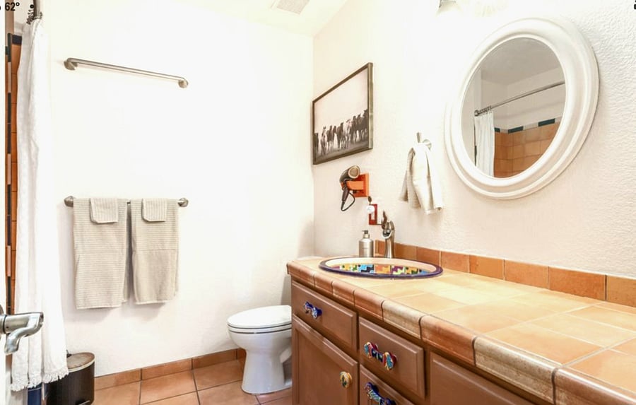 Second full bathroom with large counter and natural light