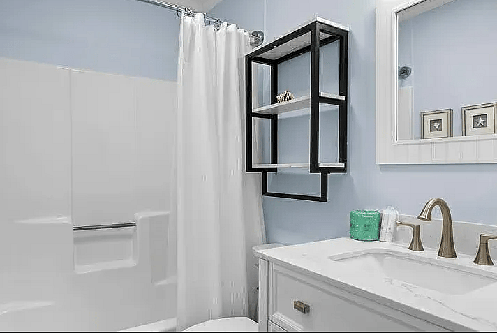 The 1st bathroom has a tub/shower combo, toilet, and single sink with vanity.