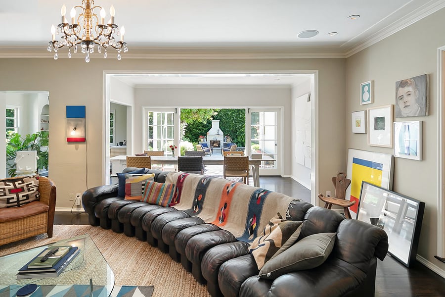 The living room featuring a leather sofa that is both stylish and comfortable.
