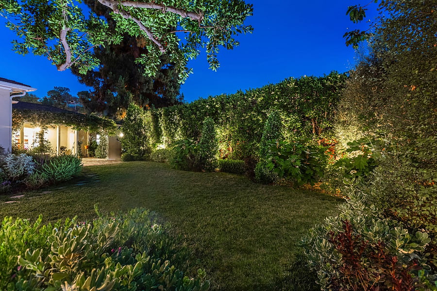 View of the backyard and dining area in the evening.