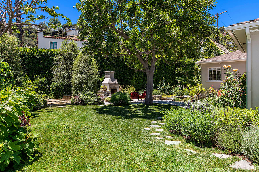 View of the backyard featuring the fire pit for cozy evenings outside.
