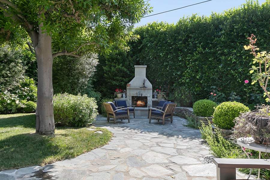 View of the backyard featuring the firepit and seating for you and your guests.