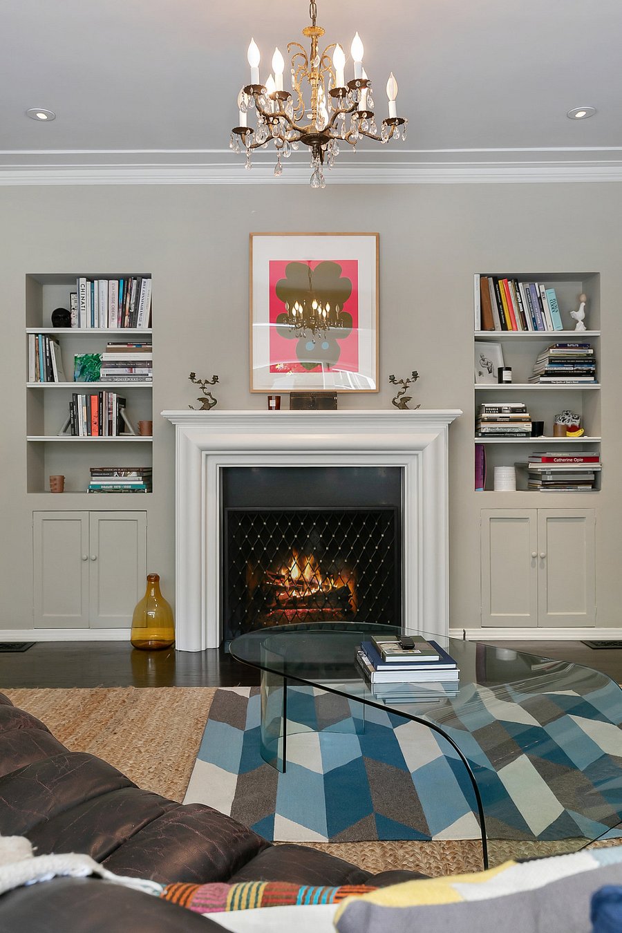 Living room featuring a fireplace that acts as a focal point for the space, featuring numerous artworks and books to read and enjoy.