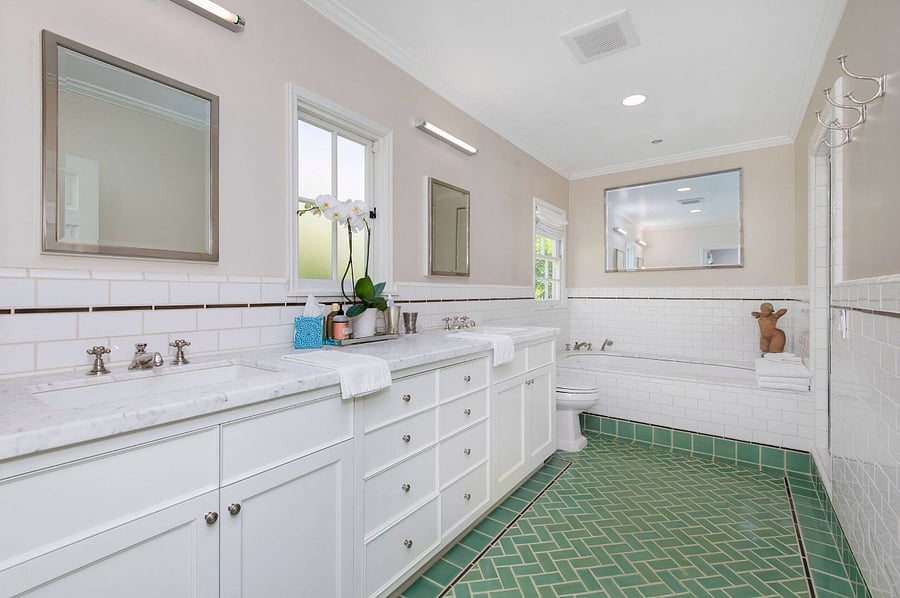 View of the master bathroom featuring a soaker tub and double sinks.
