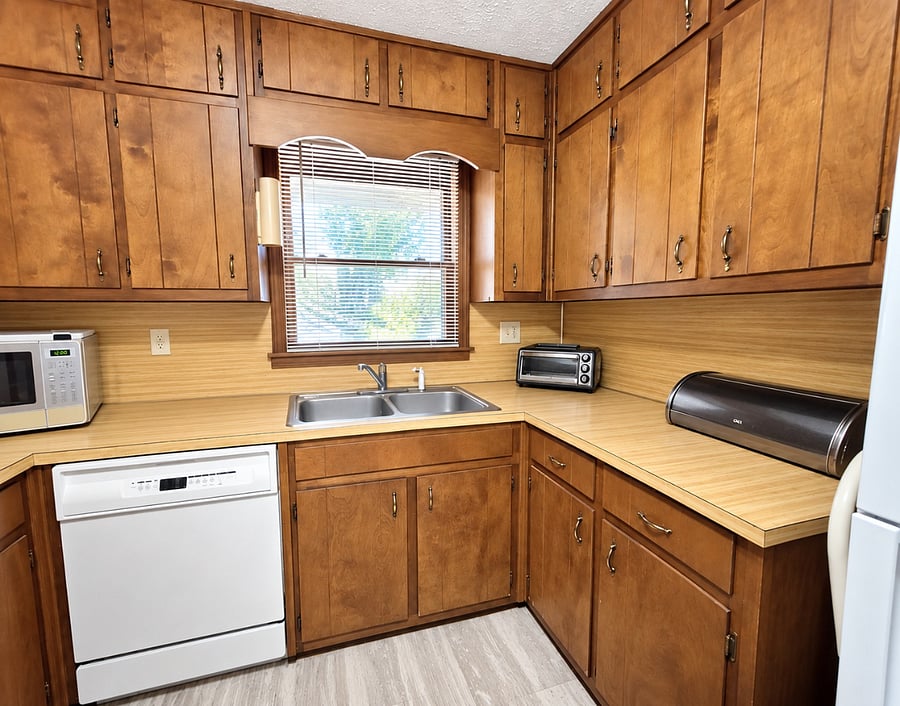 The kitchen is fully equipped with dishes, pots, pans, and cutlery. 