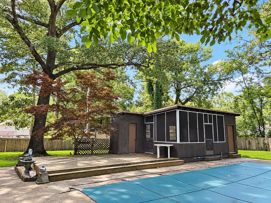 Alternate view of backyard with screened-in space to enjoy the outdoors without pest issues.