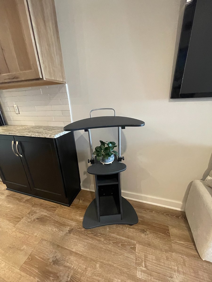 Rolling, height adjustable (great for going from standing to sitting or vice versa) 
You can also see here extra storage, that I used for a bar.