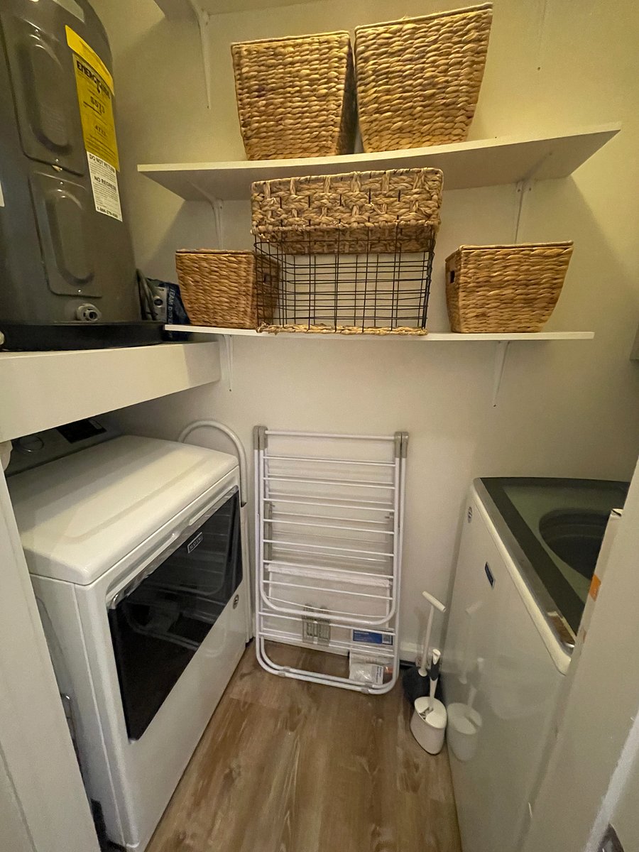 Full size washer and dryer.
Shelving with baskets for storage.