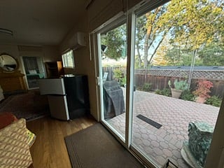 Looking out private entrance sliding glass doors.