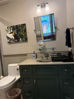 Bathroom set up to use sink for washing dishes, too.