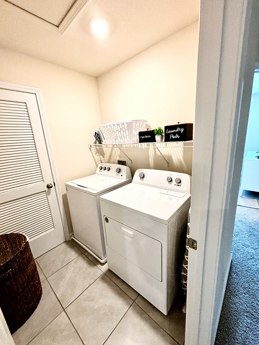 Upstairs full laundry room, in the hallway between both bedrooms