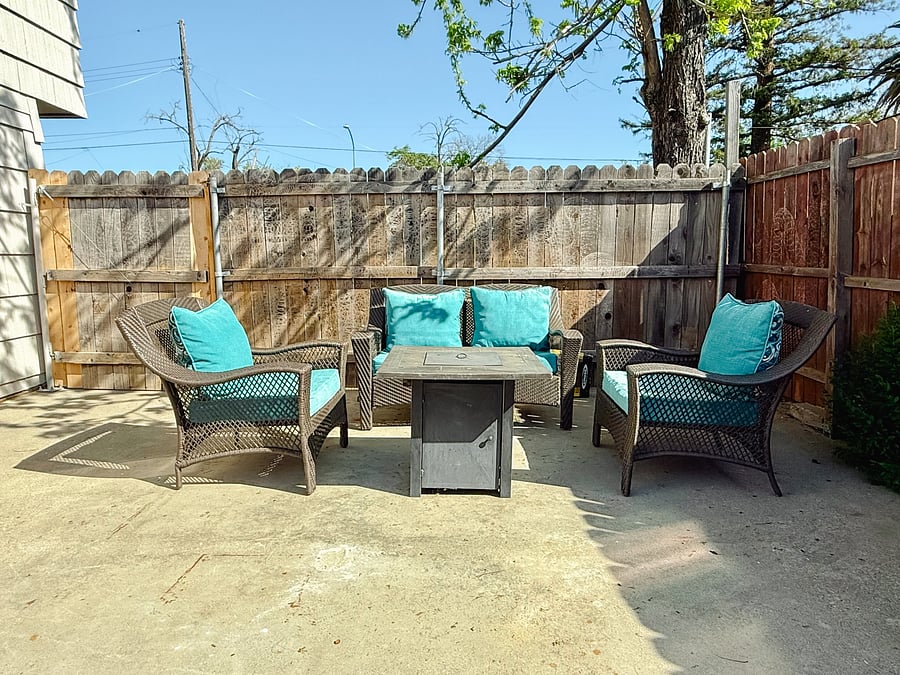 Gated Patio with fire pit and patio furniture, Outdoor table seats 6 with umbrella