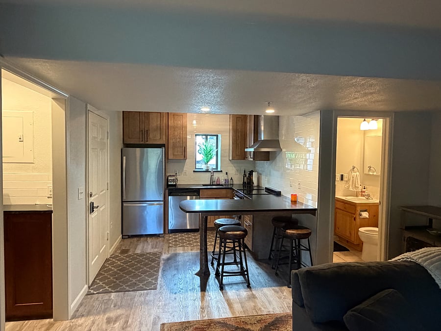 Kitchen view, pantry  and entry door on the left, restroom on the right