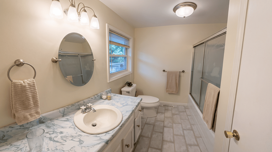 Master bathroom en-suite with shower, tub, vanity, built-in linen cupboard.