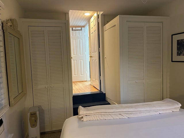 Bedroom closets (standup washer and dryer on right side) looking up the two steps into the main room.