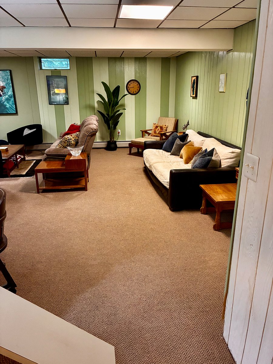 living space with 2 x couches and 3 x chairs