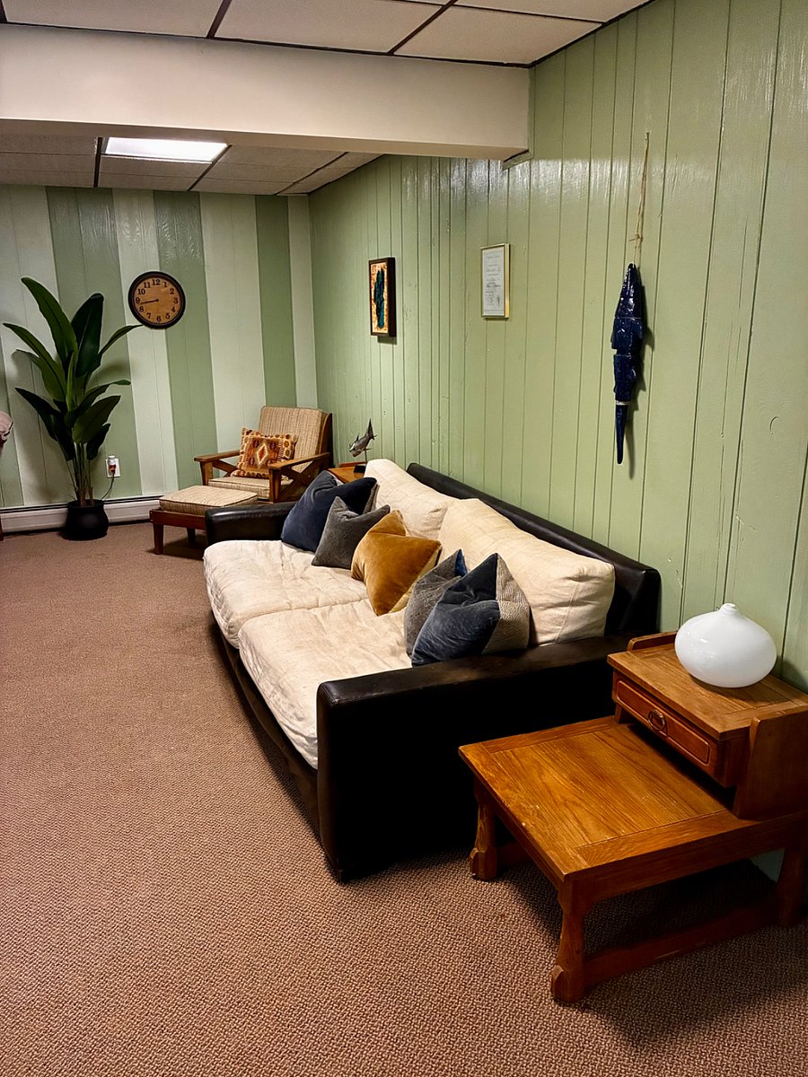 Living area second couch and chair with ottoman.