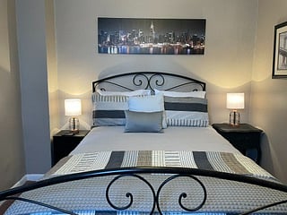 BEDROOM 1- QUEEN BED
This bedroom is decorated beautifully with earth tone colors and a tasteful NYC theme.
