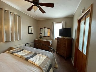 BEDROOM 1
Queen size bed, flat screen TV, dresser with mirror, end tables, lamps, window air conditioner, ceiling fan, 2 dressers with plenty of storage,