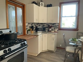 KITCHEN-Fully equipped with a GE Burner Gas Range, refrigerator, microwave, Keurig Coffee Maker, Electric Tea Pot, Blender, Cookware, Cutlery, Glassware, Kitchen Tools, Pantry/Storage Closet and a custom chef's retractable cutting board.