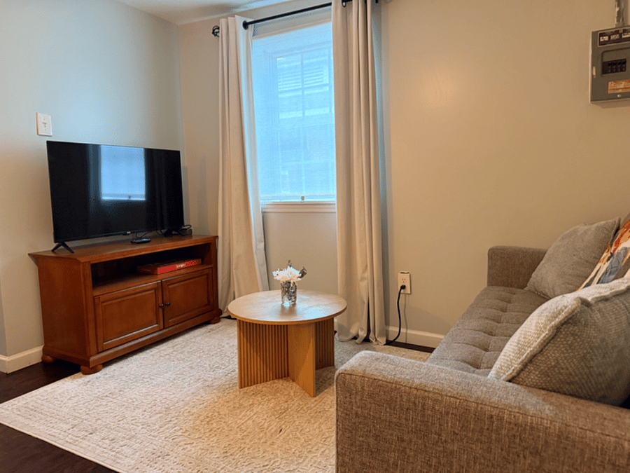 Cozy living area with a new smart tv.