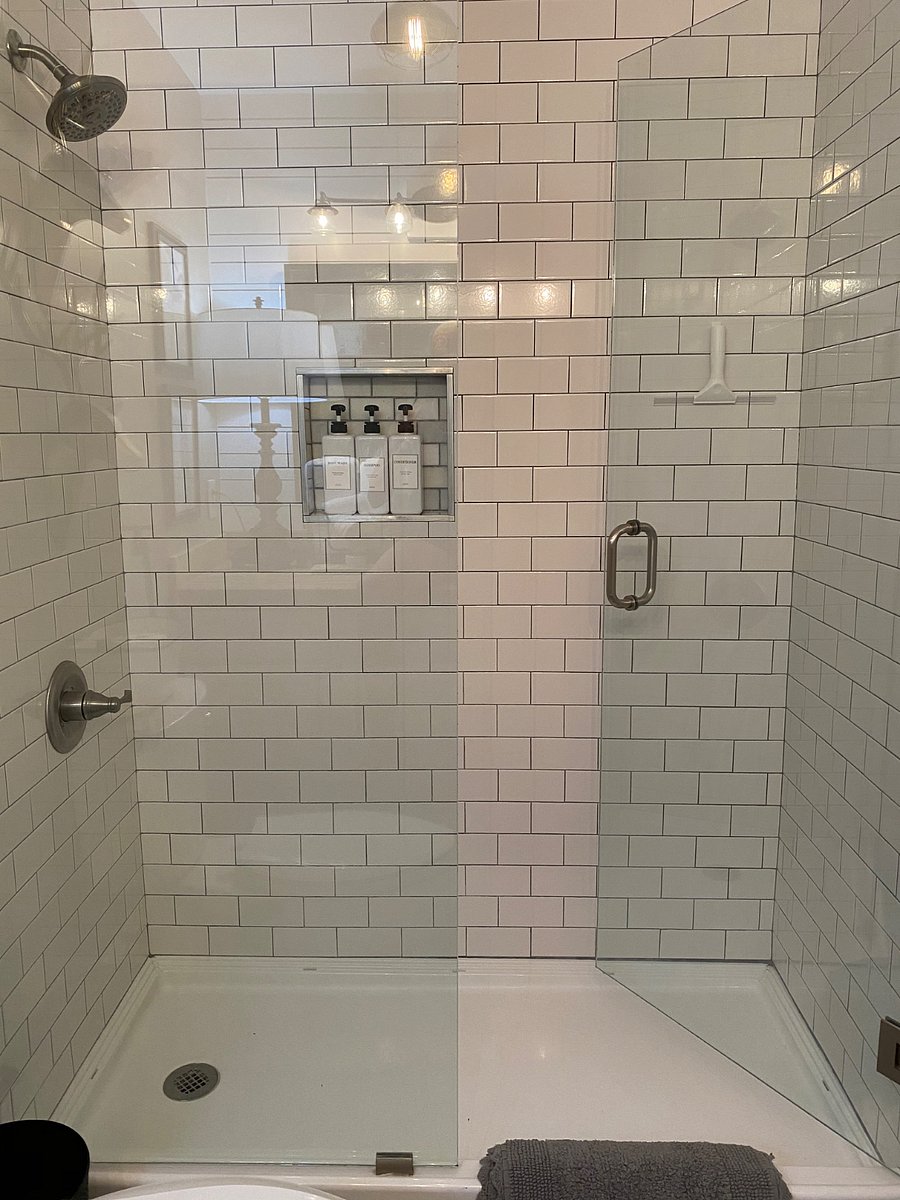 Large walk in glass shower with subway tile