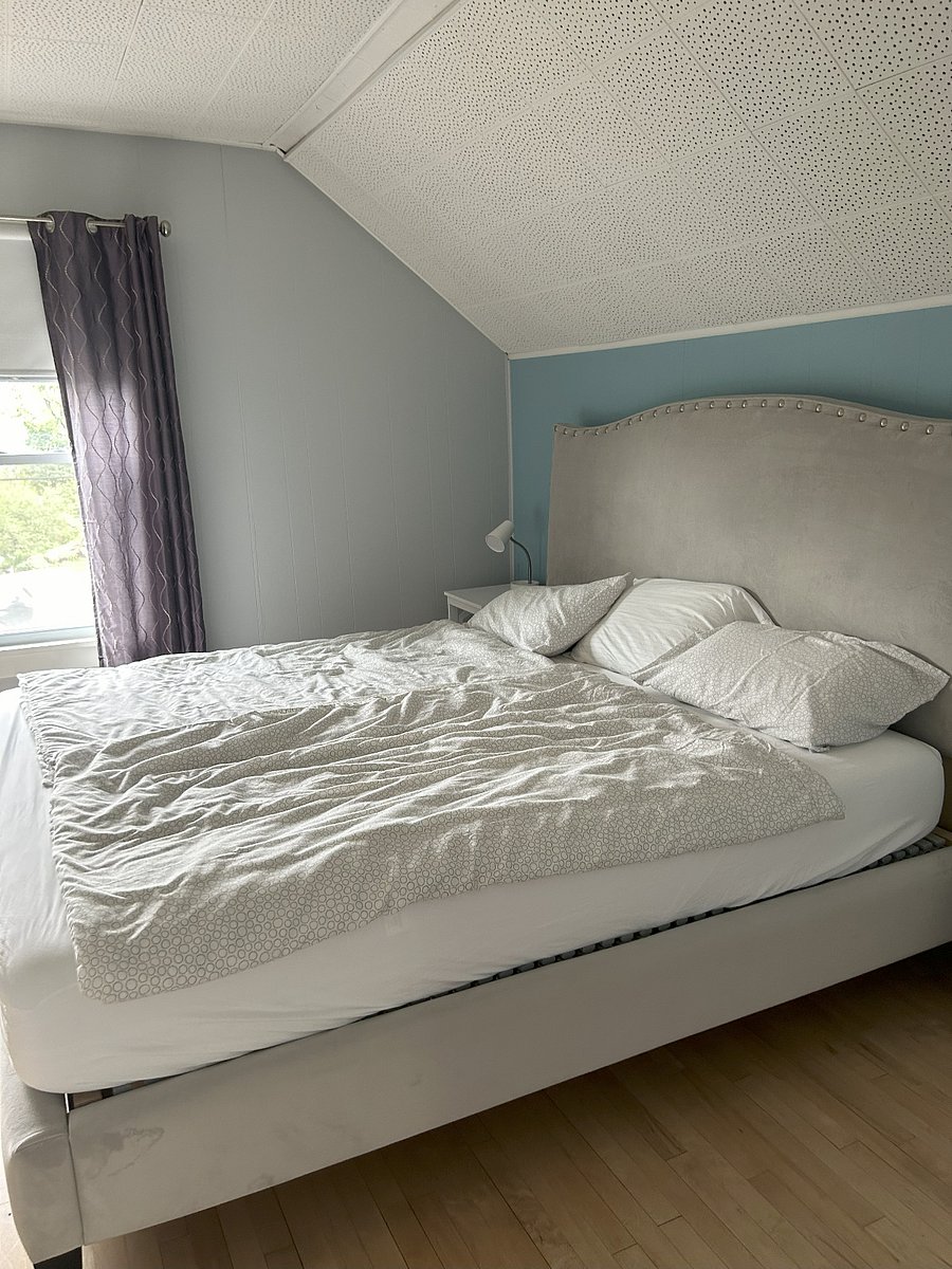 Master Bedroom with California King-sized bed, view out onto the Bay, large closet and dresser