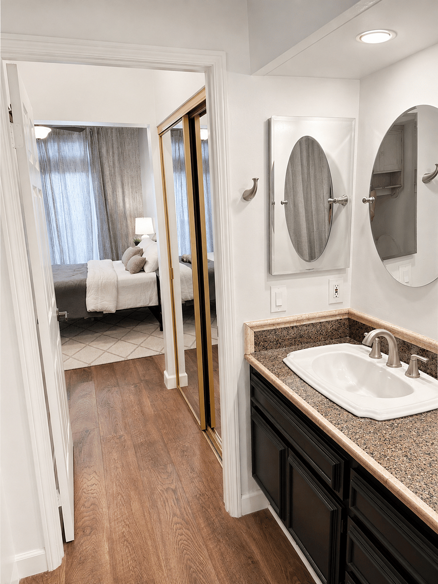 Bathroom view into closets and bedroom