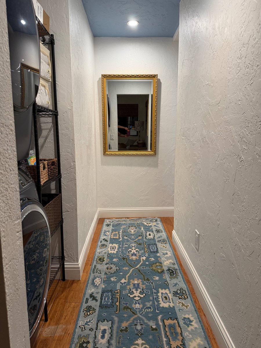 Hallway with full-size washer dryer