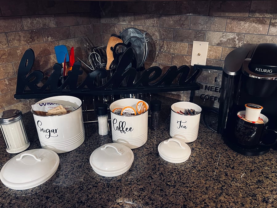 Coffee area and complementary pods. Kitchen also includes pots, pans, cooking and eating utensils as well as wine glasses.