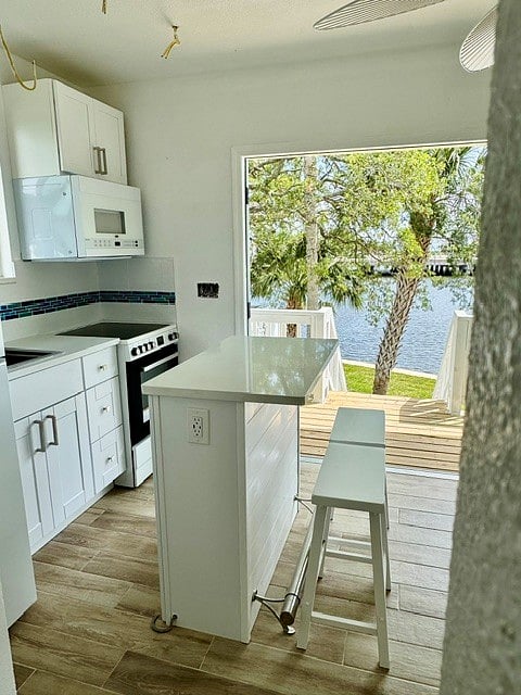 Kitchen breakfast island with view out the front double doors