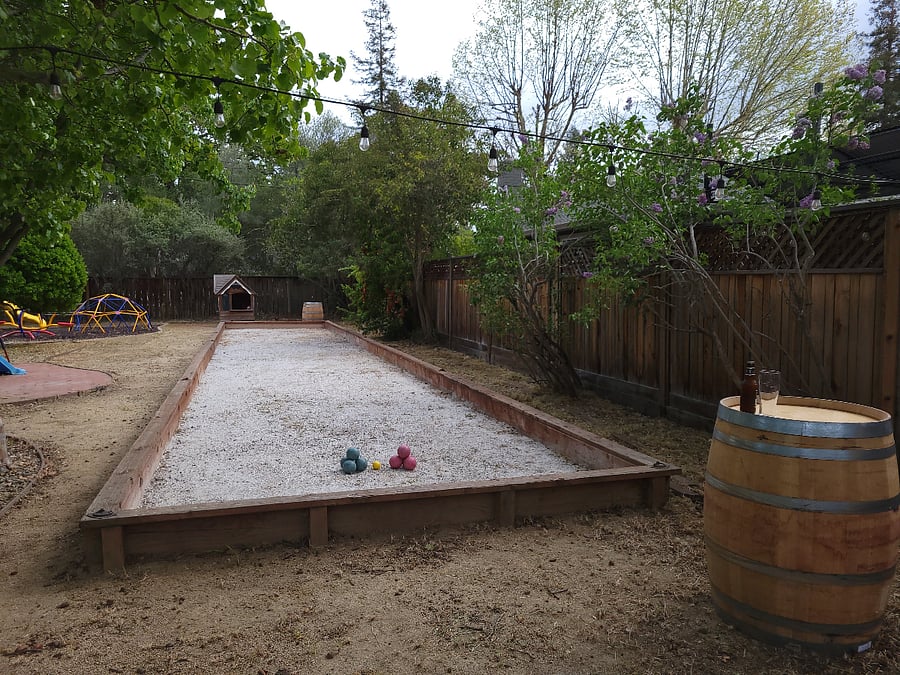 Bocce ball court with wine barrels at the end for your drinks.