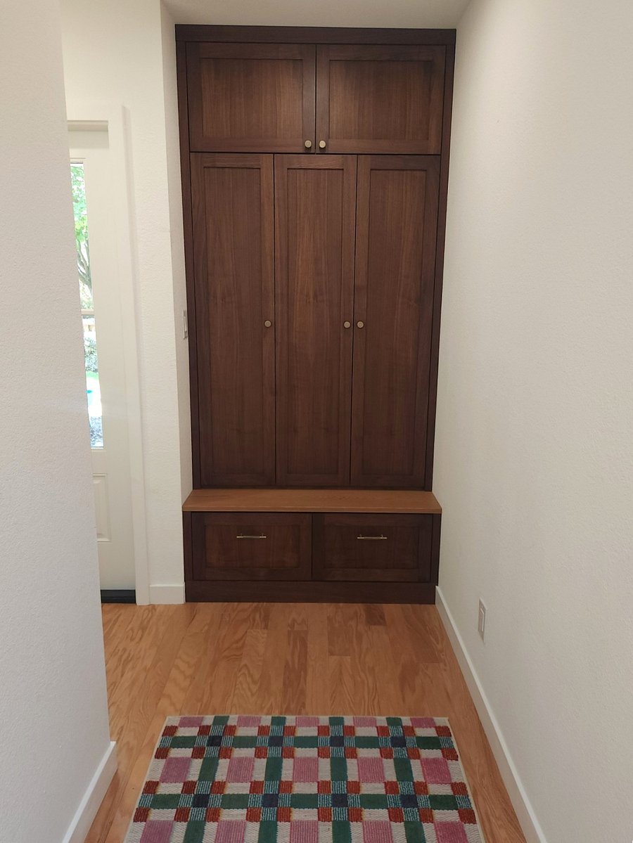 Walnut cabinet with mini fridge, freezer, and pantry with coffee, tea, chai, hot cocoa, oatmeal, sugar, basic spices, and olive oil.