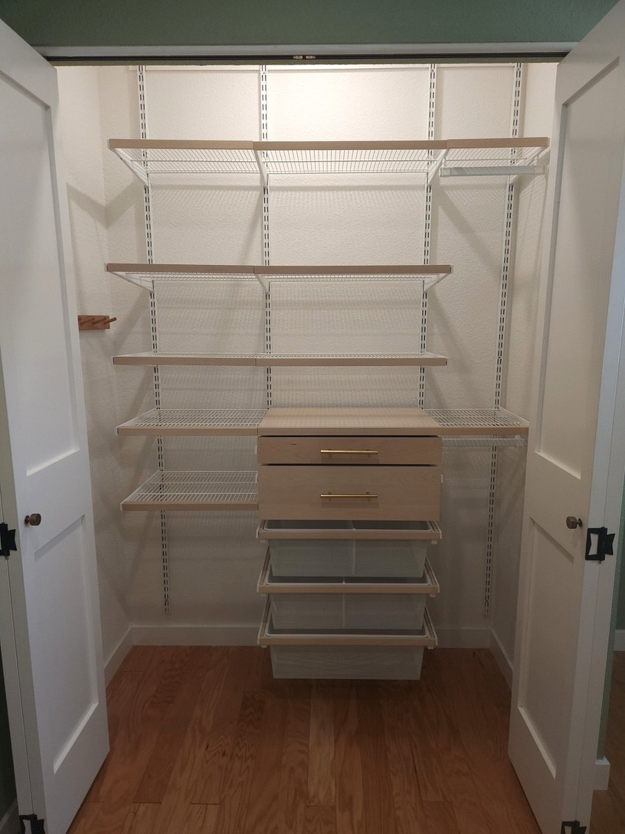 Beautiful closet from Container Store, custom built for the space, with plenty of space for your clothes.