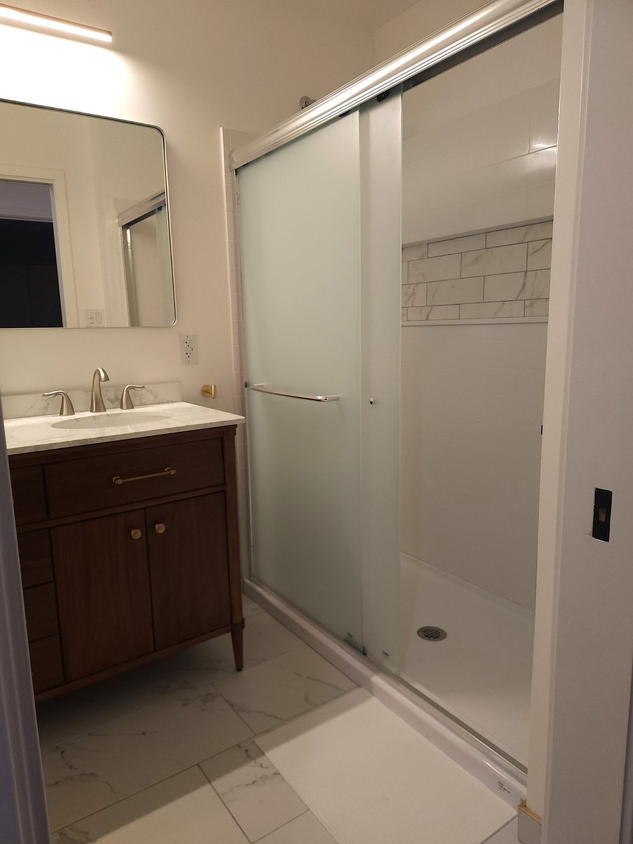 Spacious shower with a nook for showering supplies