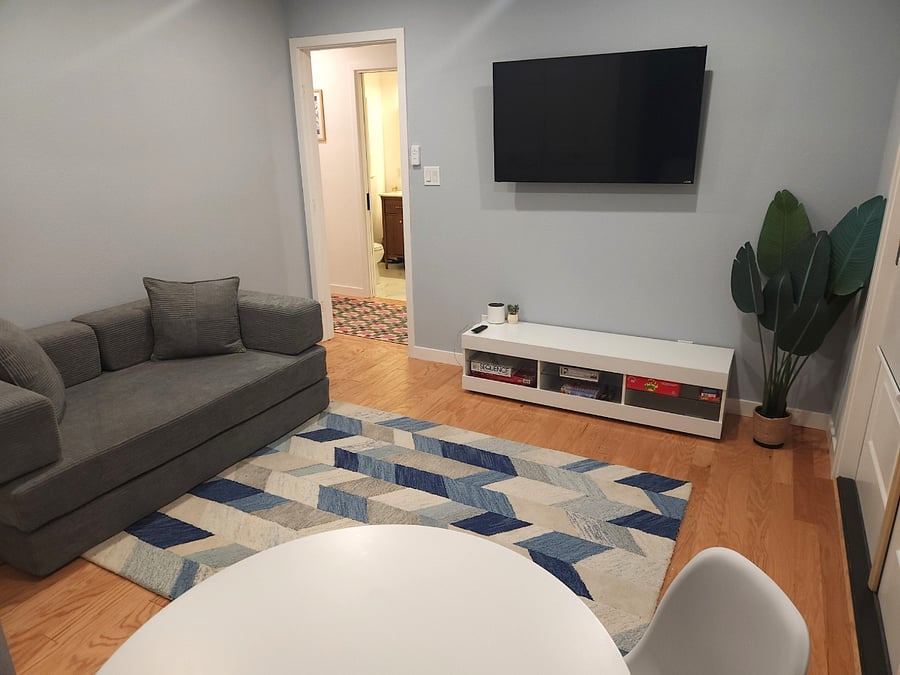 Elegant living room with hardwood floors, which opens via the French doors into the patio cafe. Smart TV for you to login and enjoy multiple streaming channels. The couch conveniently converts into a sleeper for two. Modern dining table for meals.