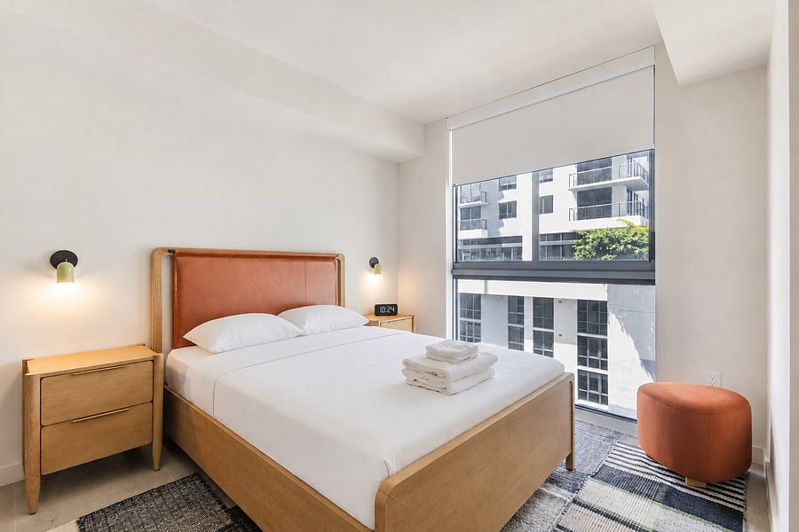 Queen size second bedroom flooded with natural light (and blackout curtains when you want to sleep in)