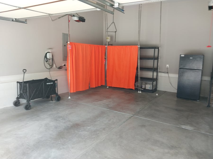 Garage with covered shelves and Tesla Charger